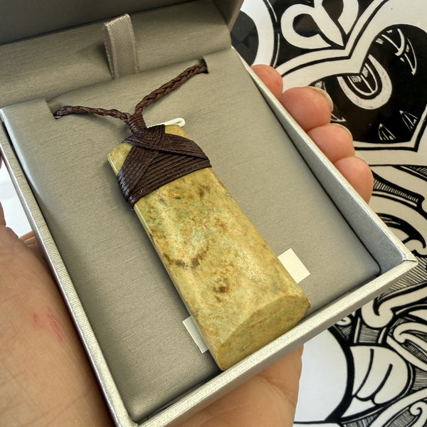 pounamu jade Stone pendant with brown cord in a  jewellery box
