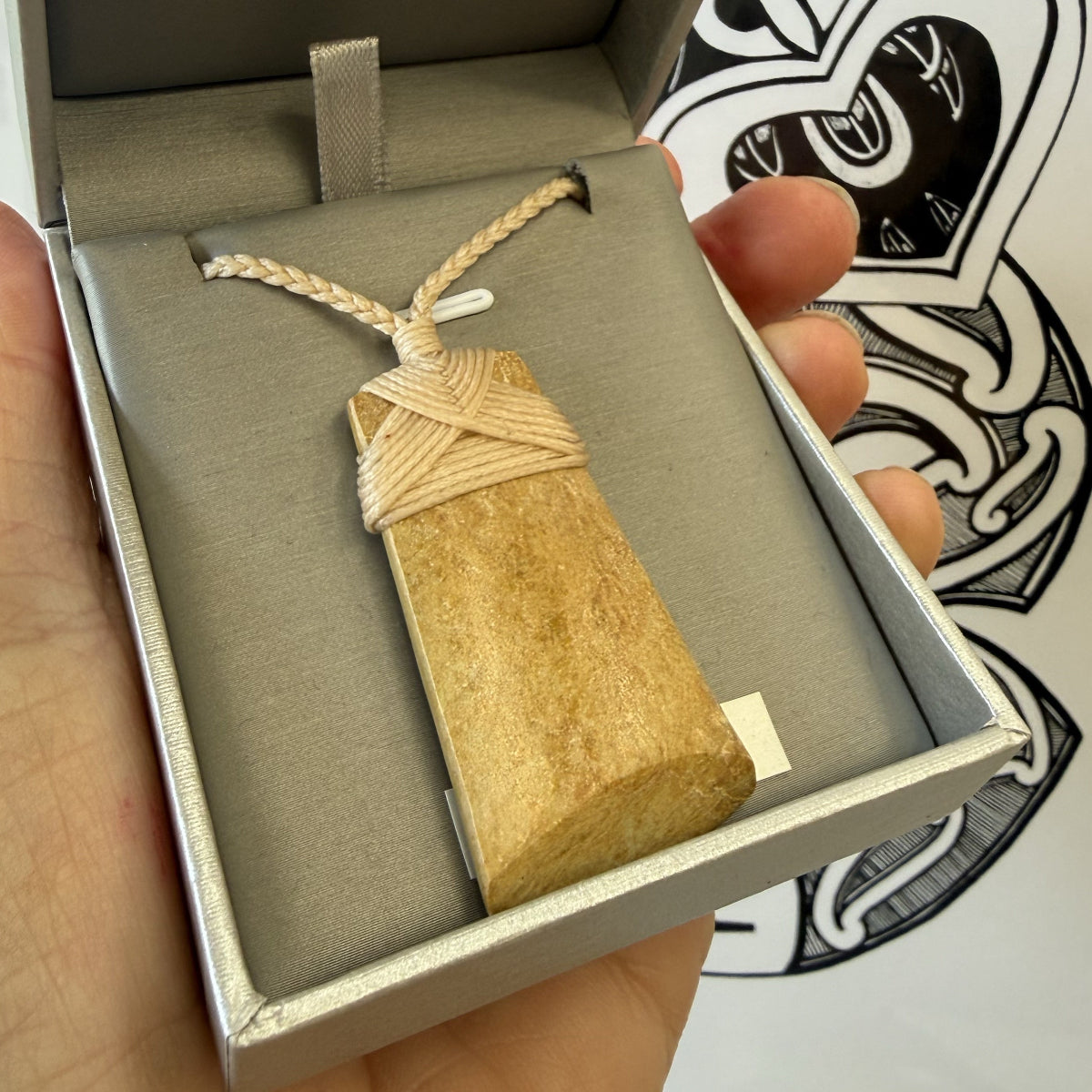 Greenstone Pounamu  pendant with a rope in a  jewellery box
